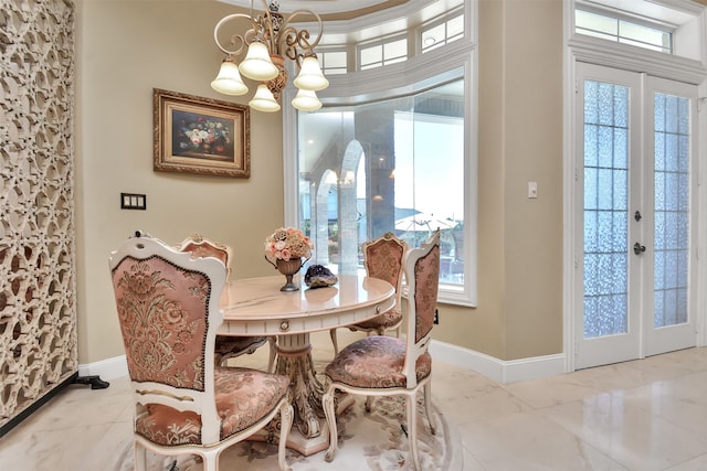 dining area featuring plenty of natural light, a chandelier, and french doors