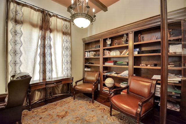 sitting room with beamed ceiling and wood-type flooring