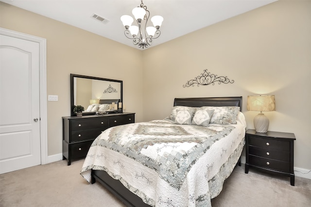 bedroom featuring a notable chandelier and light carpet