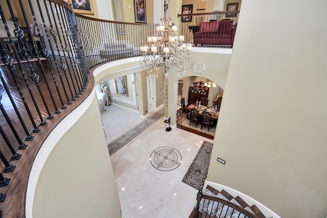 entrance foyer featuring a high ceiling and a notable chandelier