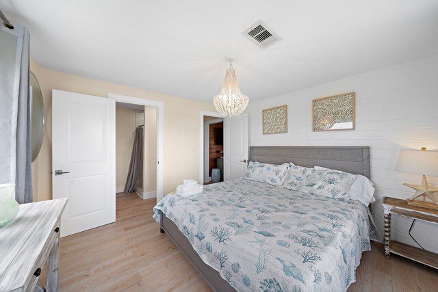 417 Olive St, Surfside Beach, TX 77541 - bedroom with light wood finished floors, a notable chandelier, baseboards, and visible vents