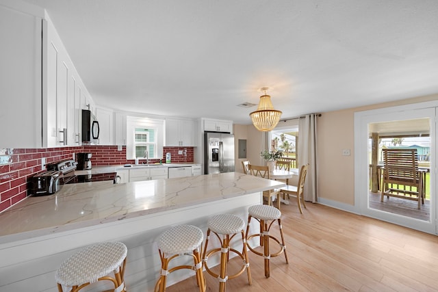 417 Olive St, Surfside Beach, TX 77541 - kitchen with a peninsula, appliances with stainless steel finishes, a healthy amount of sunlight, and a sink