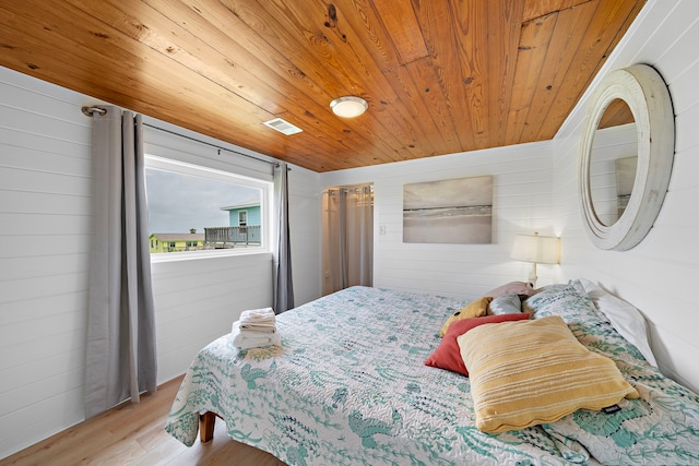 417 Olive St, Surfside Beach, TX 77541 - bedroom with wooden ceiling, wooden walls, visible vents, and wood finished floors