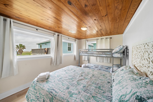 417 Olive St, Surfside Beach, TX 77541 - bedroom featuring baseboards, wood ceiling, and wood finished floors