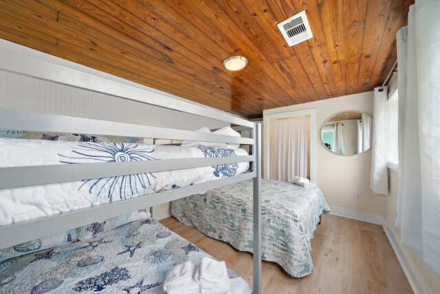 417 Olive St, Surfside Beach, TX 77541 - bedroom featuring wooden ceiling, baseboards, visible vents, and wood finished floors