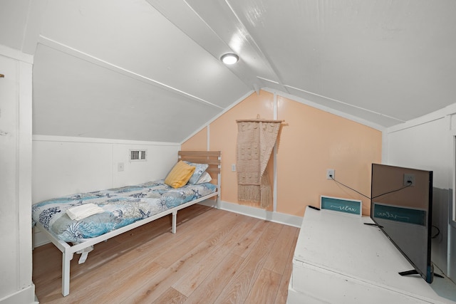 bedroom featuring wood-type flooring and vaulted ceiling