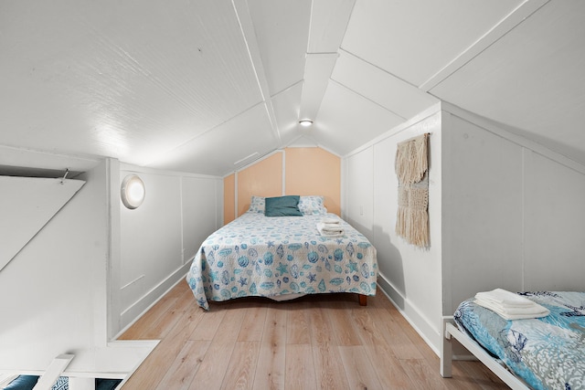 bedroom featuring vaulted ceiling and light wood-type flooring