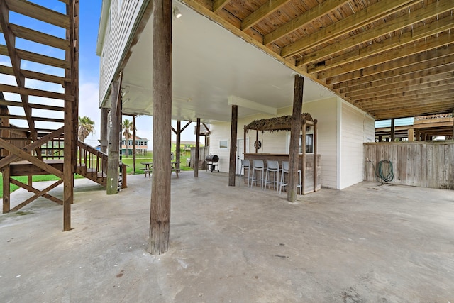 417 Olive St, Surfside Beach, TX 77541 - view of patio featuring stairs, area for grilling, and outdoor dry bar
