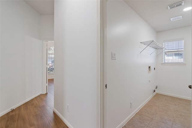 washroom featuring washer hookup, gas dryer hookup, light wood-type flooring, and a wealth of natural light