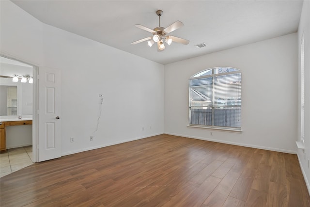 empty room featuring hardwood / wood-style flooring and ceiling fan