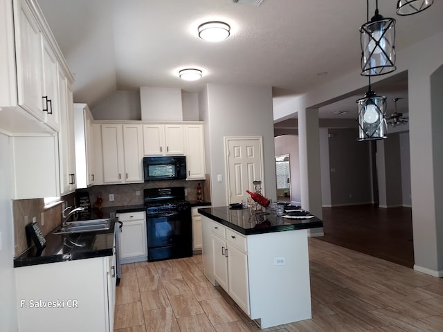 kitchen with white cabinets, sink, a kitchen island, and black appliances