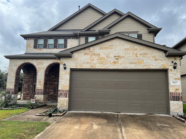 4023 Lake Cypress Cir, Houston, TX 77068 - view of front of house featuring stone siding, concrete driveway, an attached garage, and a porch