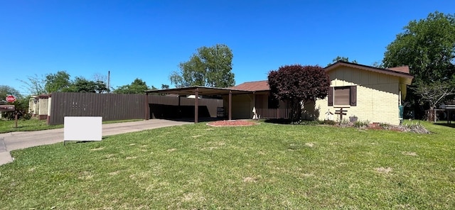 single story home featuring a carport and a front lawn