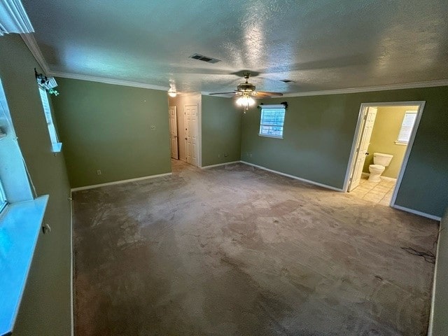 unfurnished bedroom featuring ornamental molding, ceiling fan, and carpet flooring