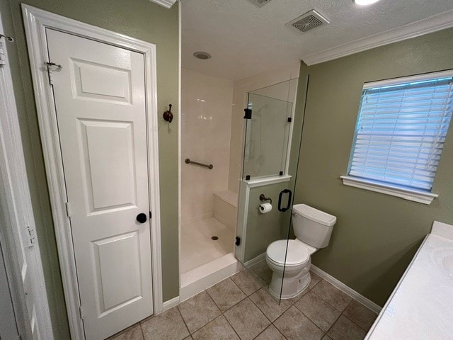 bathroom featuring tile patterned floors, walk in shower, toilet, vanity, and a textured ceiling