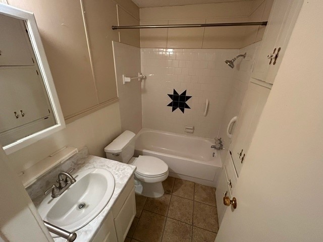 full bathroom featuring vanity, toilet, tiled shower / bath combo, and tile patterned floors