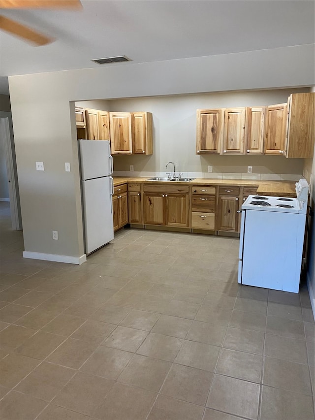 kitchen with ceiling fan, sink, light tile patterned floors, and white appliances