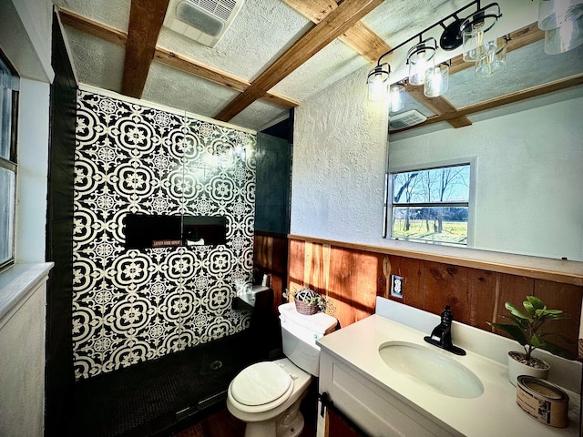 bathroom featuring vanity, coffered ceiling, beam ceiling, toilet, and wooden walls