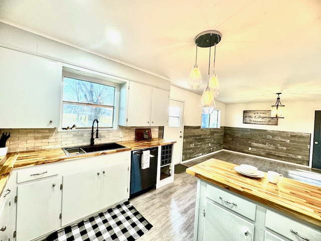 kitchen with dishwasher, pendant lighting, sink, butcher block counters, and white cabinets