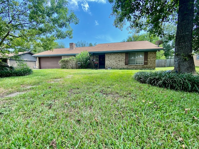 ranch-style house with a garage and a front lawn