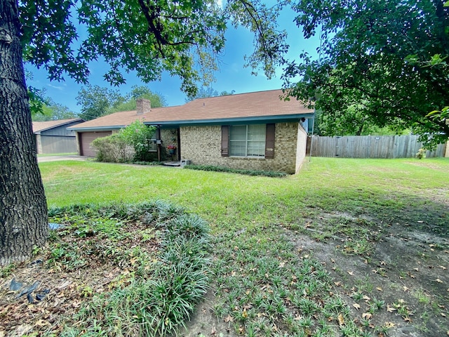 view of front of property with a front yard and a garage