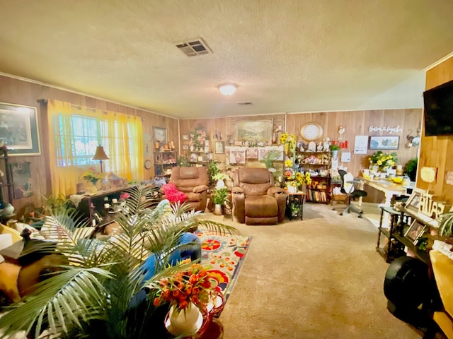 carpeted living room featuring a textured ceiling and wood walls