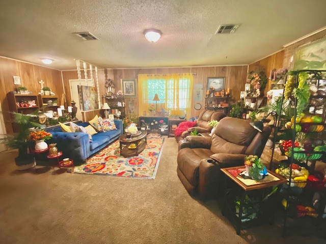 carpeted living room with a textured ceiling and wooden walls