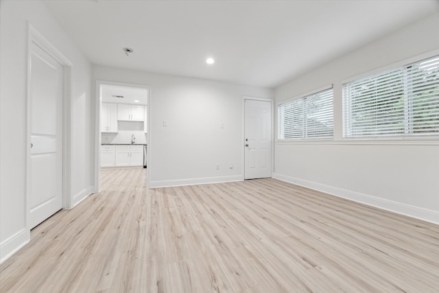 empty room with light hardwood / wood-style flooring