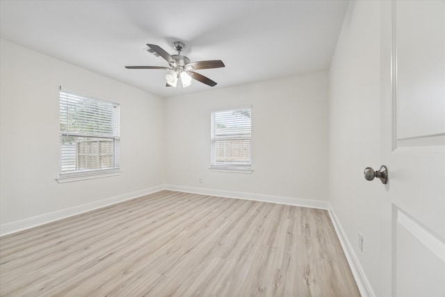 unfurnished room featuring light wood-type flooring, a wealth of natural light, and ceiling fan