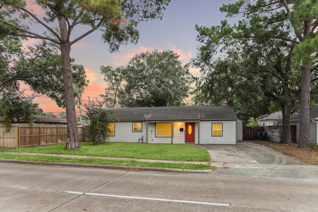 ranch-style house featuring a lawn