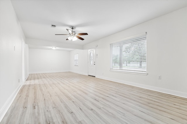 spare room featuring light wood-type flooring and ceiling fan