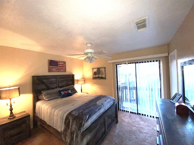 carpeted bedroom featuring a textured ceiling, access to exterior, and ceiling fan