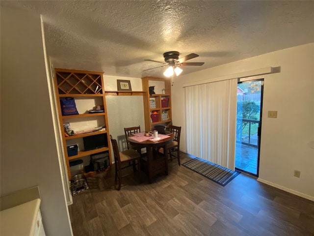 dining room with a textured ceiling, dark wood-type flooring, and ceiling fan