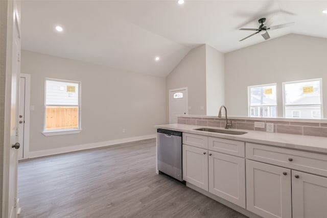 kitchen featuring light hardwood / wood-style flooring, sink, lofted ceiling, ceiling fan, and stainless steel dishwasher