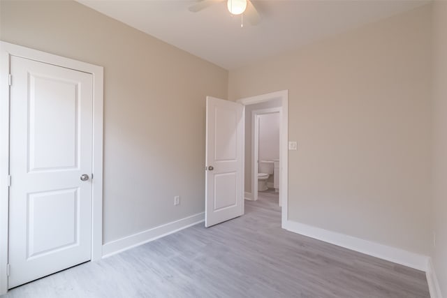 empty room featuring ceiling fan and light hardwood / wood-style flooring