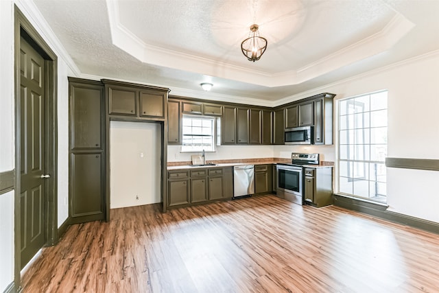 kitchen featuring appliances with stainless steel finishes, sink, dark hardwood / wood-style floors, a raised ceiling, and a textured ceiling