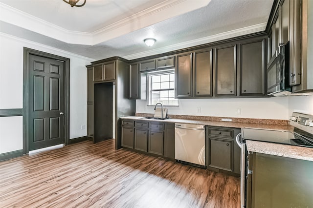 kitchen with appliances with stainless steel finishes, wood-type flooring, crown molding, and sink