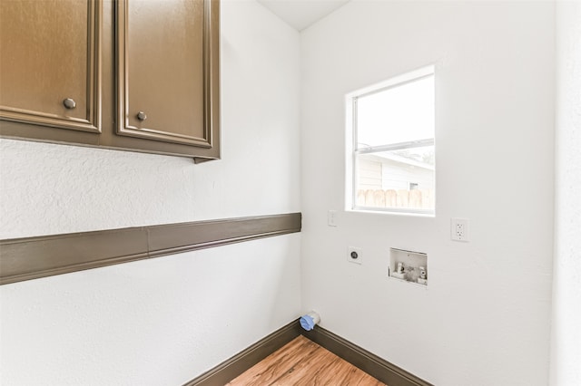 laundry room with washer hookup, cabinets, electric dryer hookup, and wood-type flooring