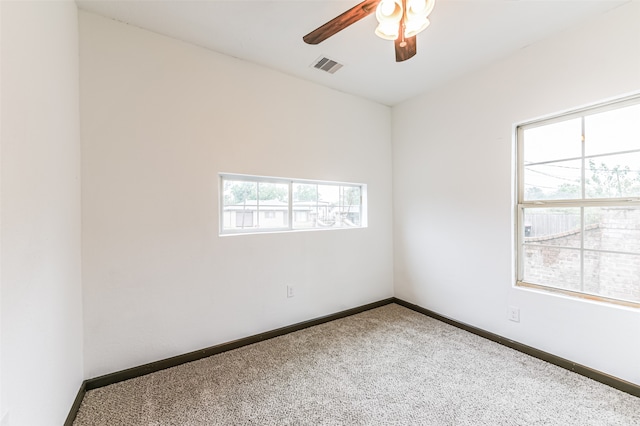 carpeted empty room featuring ceiling fan