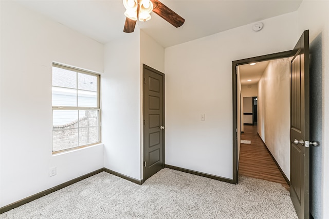 unfurnished bedroom with ceiling fan and light hardwood / wood-style flooring