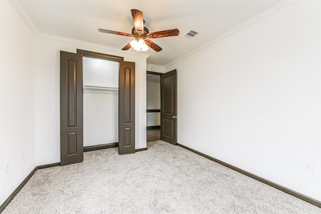 unfurnished bedroom with crown molding, carpet flooring, and ceiling fan