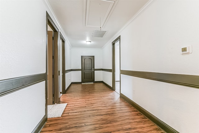 corridor with crown molding and hardwood / wood-style floors