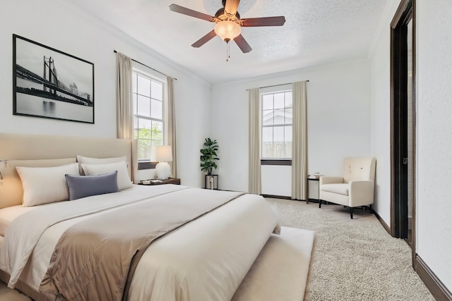 bedroom with a textured ceiling, light colored carpet, ceiling fan, and ornamental molding