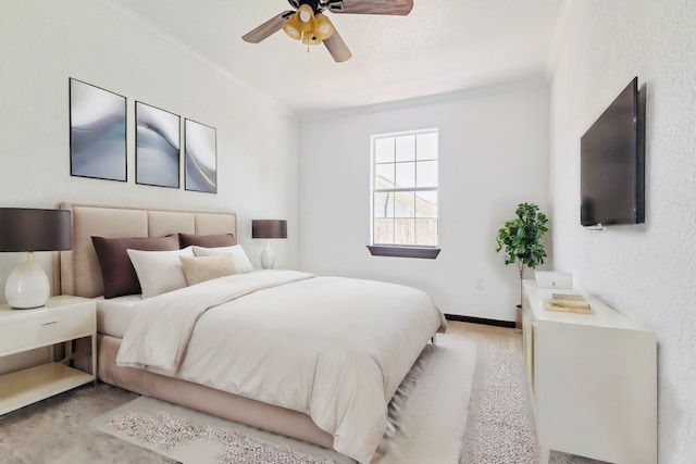 carpeted bedroom with ceiling fan and crown molding