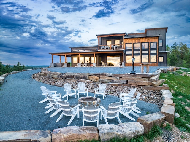 back of house with an outdoor fire pit