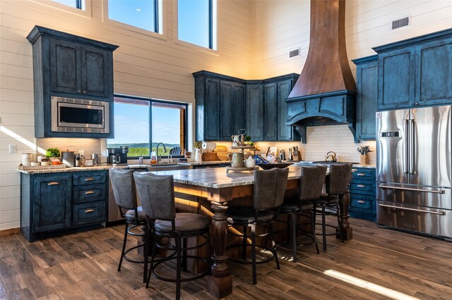 kitchen featuring plenty of natural light, appliances with stainless steel finishes, and dark wood-type flooring