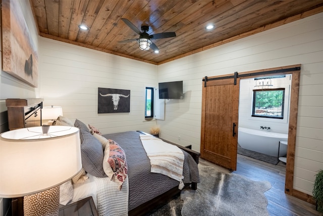 bedroom with a barn door, wood-type flooring, wooden ceiling, and ceiling fan