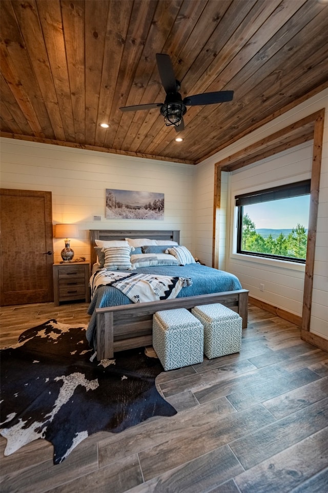 bedroom featuring wood ceiling, wood-type flooring, wood walls, and ceiling fan