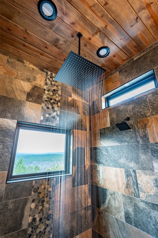 bathroom with wooden ceiling and a tile shower