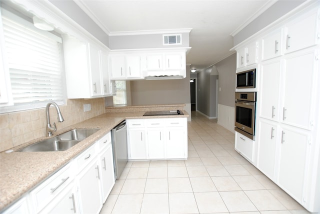 kitchen featuring kitchen peninsula, sink, appliances with stainless steel finishes, and white cabinetry